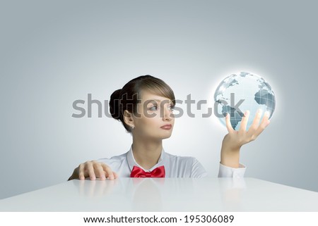 Young woman holding digital Earth planet in hand
