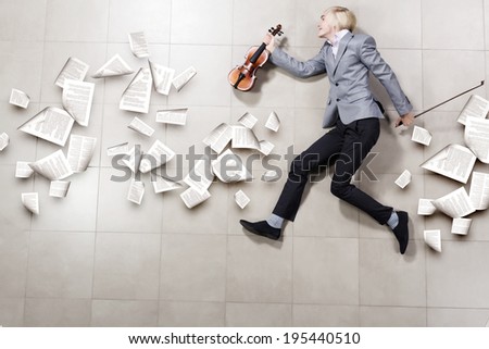 Funny image of running businessman with violin in hand