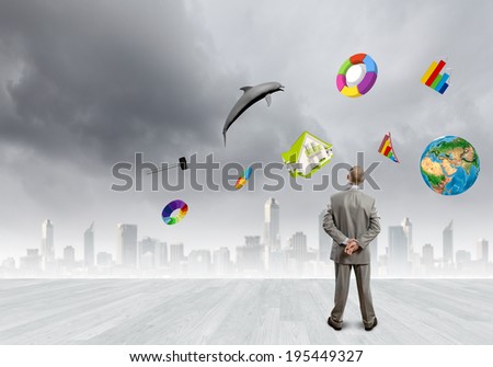 Back view of confident businessman looking at items flying in air. Elements of this image are furnished by NASA