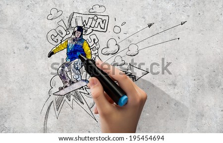 Close up of hand drawing sketches of snowboarder