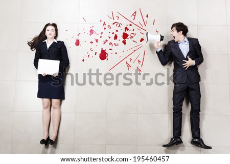 Angry businessman shouting in megaphone on his colleague