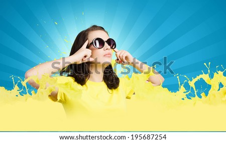 Young girl teenager in sunglasses and yellow shirt