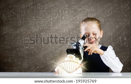 Cute school girl examining dna molecule with microscope