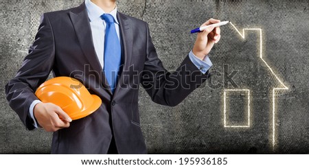 Young man engineer drawing sketches of construction project