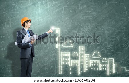 Young man engineer touching icon of media screen