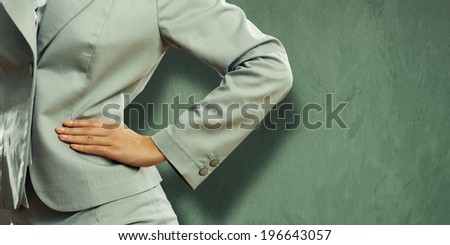 Close up of confident businesswoman with hand on waist