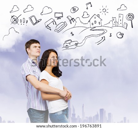 Young couple hugging each other and dreaming about future