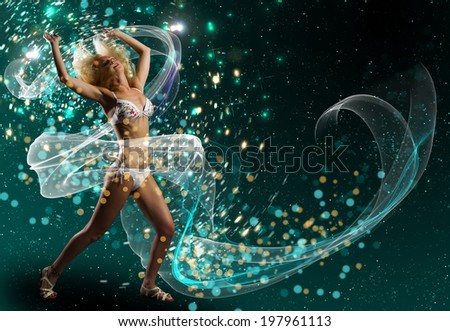Young woman in white bikini dancing against color background