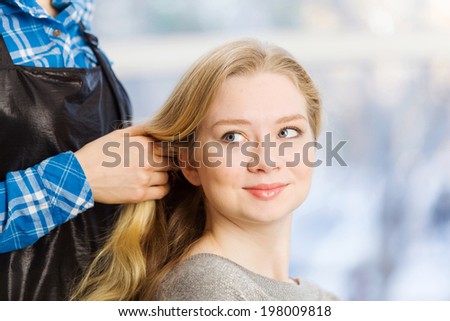 Young woman in chair at barbers and hairdresser