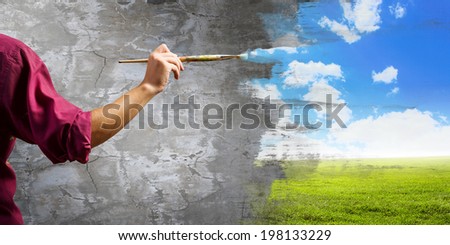 Close up of painter\'s hand with brush