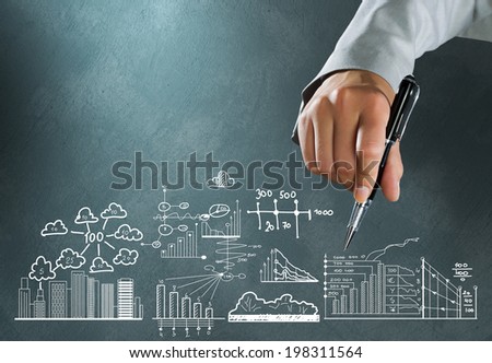 Close up of businesswoman hand drawing business sketches