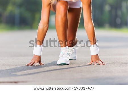 Bottom view of young sport woman in start pose