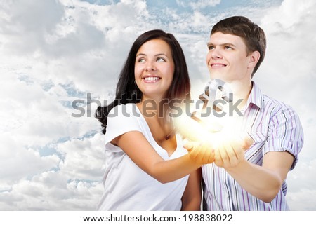 Young happy couple holding pound sign in palms