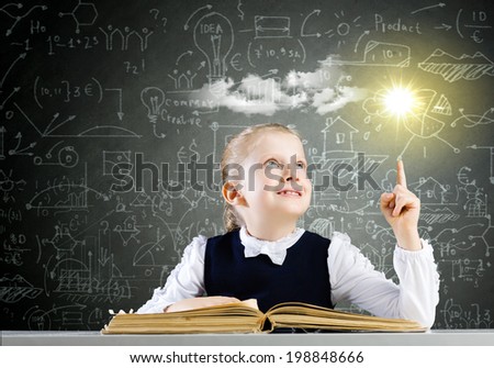 Schoolgirl at lesson with opened book against sketch background