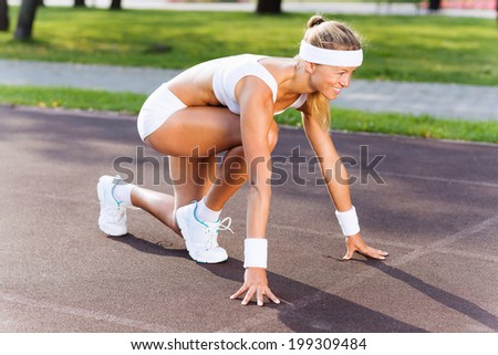 Bottom view of young sport woman in start pose