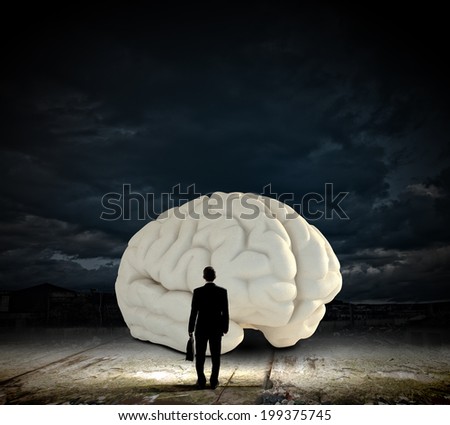 Rear view of businessman looking at big brain model