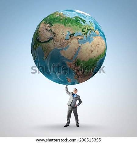 Businessman holding huge Earth planet above head. Elements of this image are furnished by NASA