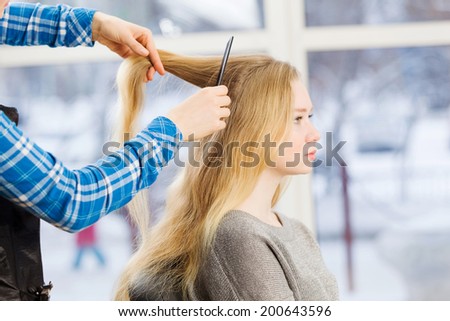 Young woman in chair at barbers and hairdresser