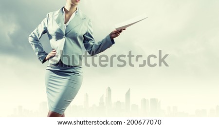 Close up of businesswoman holding papers in hands
