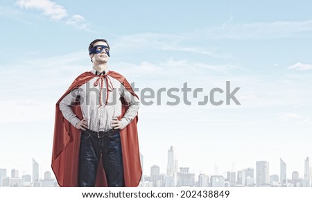 Young man wearing mask and cape