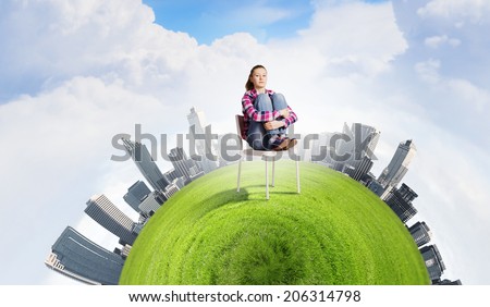 Young troubled woman sitting in chair on green planet