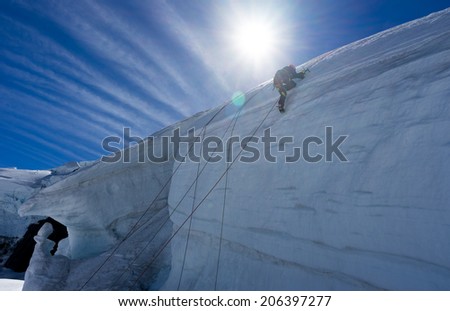Low angle view of man climbing glacier