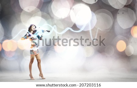Young attractive woman in colored dress playing violin