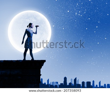 Silhouette of woman looking in binoculars with big full moon at background