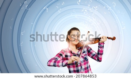 Young pretty woman in casual playing on violin
