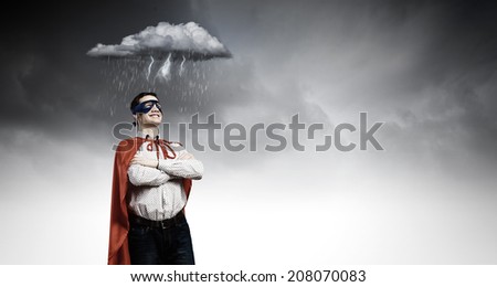 Young man wearing man mask and cape