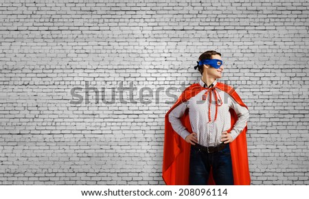 Young man wearing man mask and cape