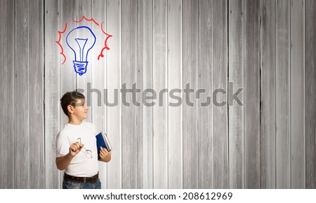 Schoolboy with books and light bulb. Idea concept