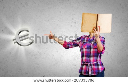 Young woman reading book and pointing at euro sign