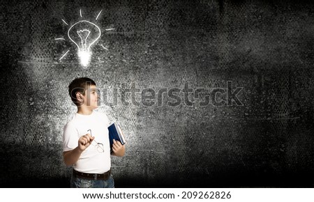 Schoolboy with books and light bulb. Idea concept