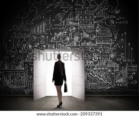 Silhouette of businesswoman with briefcase standing in doorway