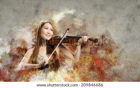 Young pretty asian woman playing violin. Young talent