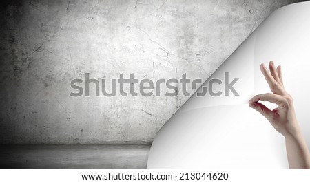 Human hand turning white blank paper page