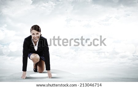 Young attractive businesswoman standing in start position