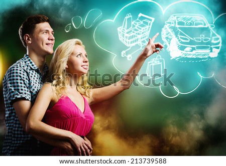 Young happy couple dreaming about buying car