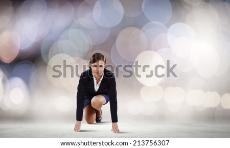 Young attractive businesswoman standing in start position
