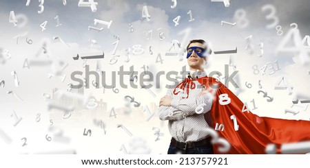 Young man wearing superman mask and cape