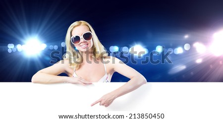 Girl in swim wear holding white blank banner. Place for text
