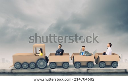 Business people riding carton train. Teamwork concept