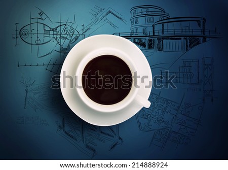 Close up of cup of coffee and construction sketches at background