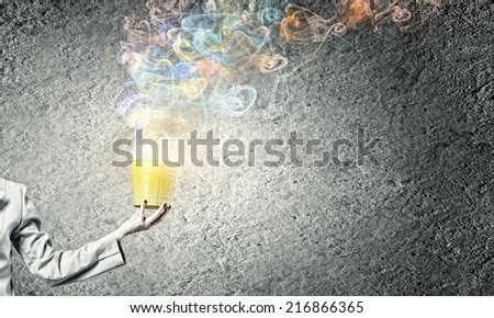Close up of businesswoman hand holding bucket with loops
