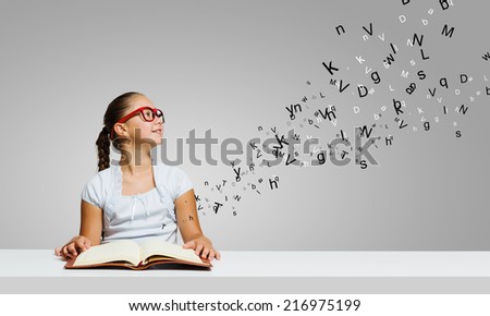 Cute girl of school age with book in hands