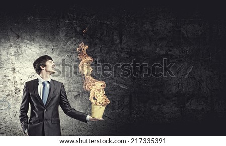 Young businessman hand holding yellow bucket in hand
