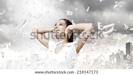 Young woman closing her ears with palms and enjoying the silence