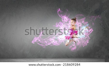 Little cute girl gymnast making high jump