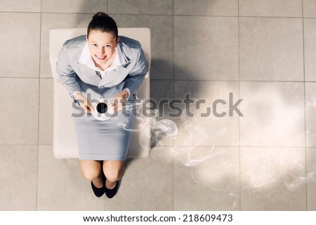 Top view of young businesswoman sitting on chair